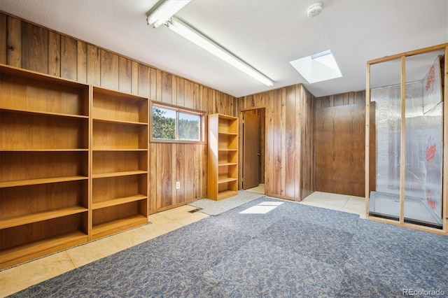 8045 S Wagon Wheel Rd, Morrison, CO 80465 - spare room with a skylight, wooden walls, and a smoke detector