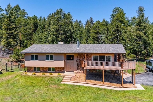 8045 S Wagon Wheel Rd, Morrison, CO 80465 - view of front of home with stone siding, a wooden deck, and a forest view