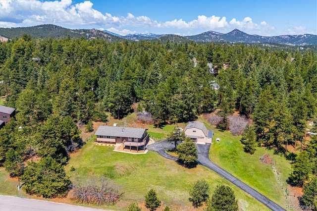 8045 S Wagon Wheel Rd, Morrison, CO 80465 - aerial view of property's location featuring a mountainous background and a heavily wooded area