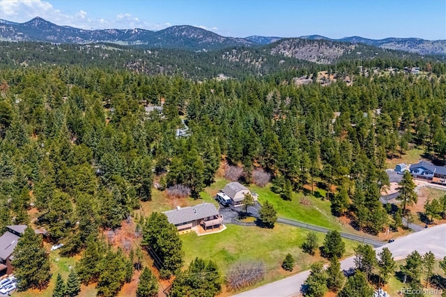 8045 S Wagon Wheel Rd, Morrison, CO 80465 - view of property location with a mountain backdrop and a forest
