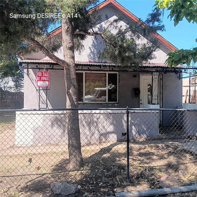 2831 Lawrence St, Denver, CO 80205 - view of side of property featuring stucco siding and a fenced front yard