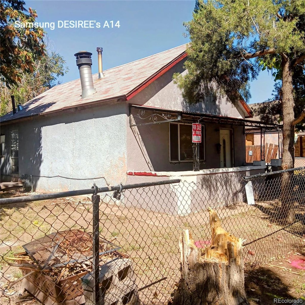 2831 Lawrence St, Denver, CO 80205 - exterior space with fence and stucco siding