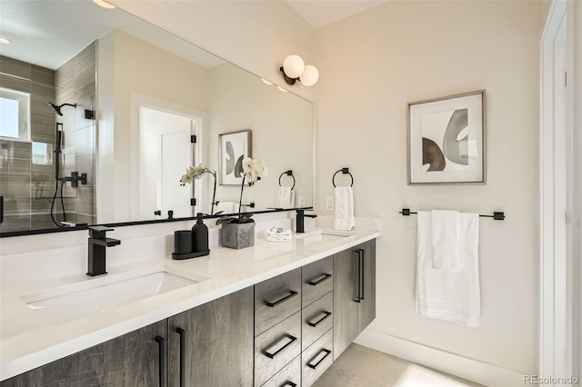 bathroom featuring a stall shower and double vanity