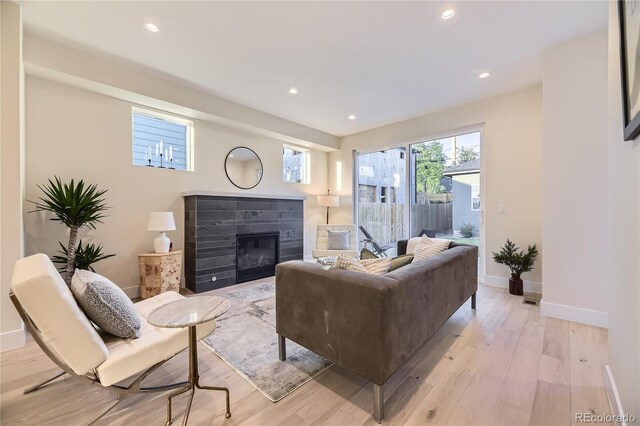 2466 S Cherokee St, Denver, CO 80223 - living room with a glass covered fireplace, light wood-type flooring, and recessed lighting
