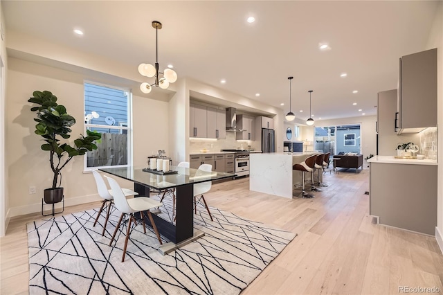 2466 S Cherokee St, Denver, CO 80223 - dining room featuring light wood-type flooring and recessed lighting