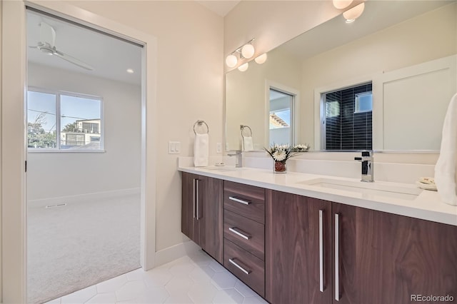 2466 S Cherokee St, Denver, CO 80223 - full bath with double vanity, tile patterned flooring, and ceiling fan