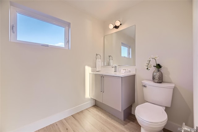 2466 S Cherokee St, Denver, CO 80223 - half bath featuring vanity and wood finished floors