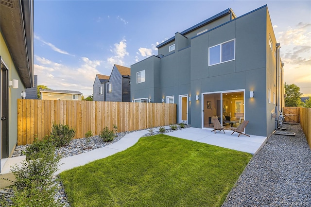 2466 S Cherokee St, Denver, CO 80223 - back of house with a patio, stucco siding, and a fenced backyard