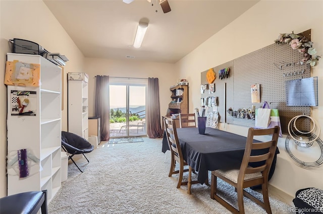 dining space with carpet floors and ceiling fan