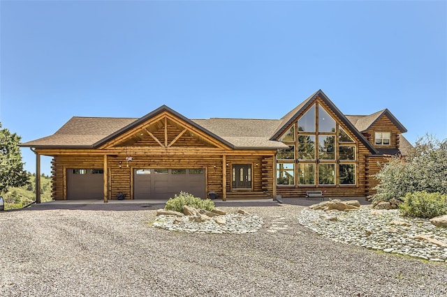 log home featuring a garage