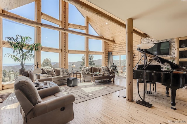 interior space with vaulted ceiling with beams and a mountain view