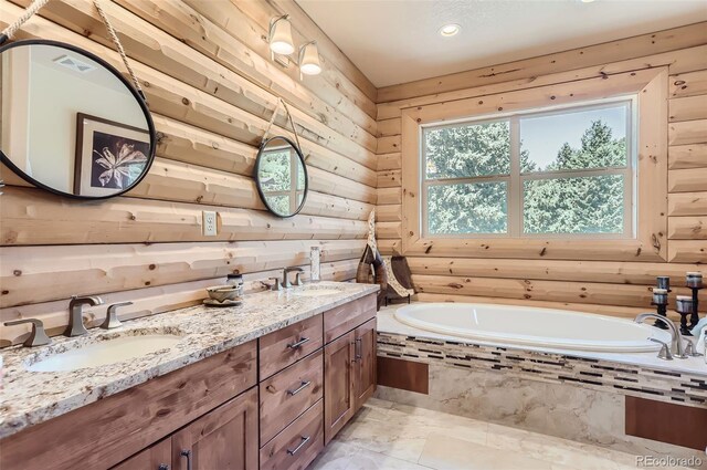 bathroom featuring tiled tub, vanity, and tile patterned floors