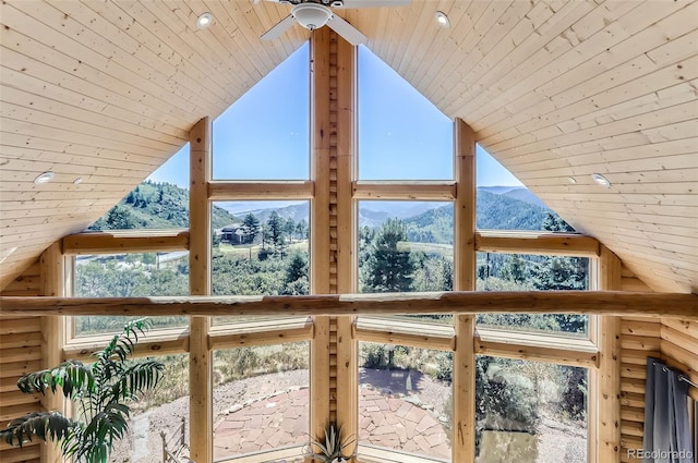 interior space with lofted ceiling, ceiling fan, a mountain view, and wood ceiling