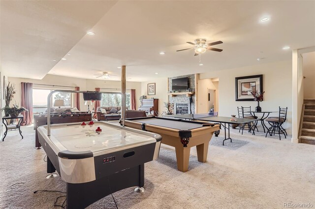 game room with pool table, ceiling fan, light carpet, and a stone fireplace