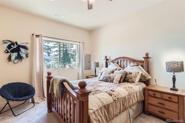 bedroom with light colored carpet, ceiling fan, and visible vents