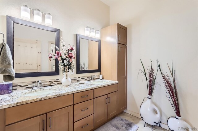 bathroom with vanity and decorative backsplash