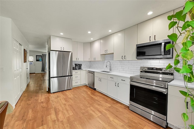 6765 S Independence St, Littleton, CO 80128 - kitchen with appliances with stainless steel finishes, a sink, light countertops, decorative backsplash, and recessed lighting