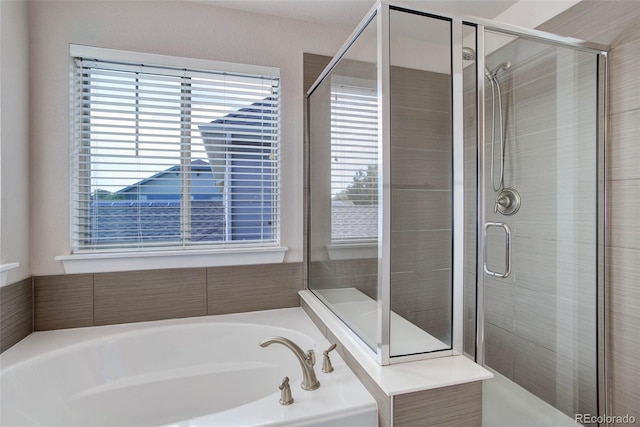 bathroom with separate shower and tub