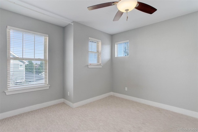 carpeted empty room featuring ceiling fan