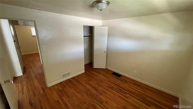 1160 Yosemite St, Denver, CO 80220 - unfurnished bedroom with dark wood-type flooring and a closet