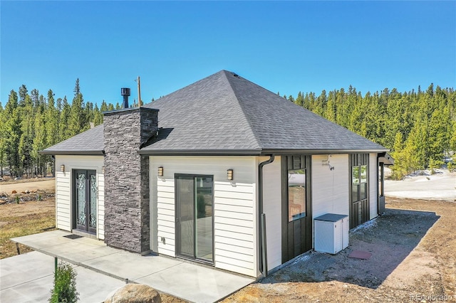 499 Silver Creek Rd, Idaho Springs, CO 80452 - back of house with a shingled roof and a chimney