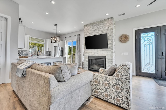 499 Silver Creek Rd, Idaho Springs, CO 80452 - living room featuring a fireplace, light wood finished floors, and recessed lighting