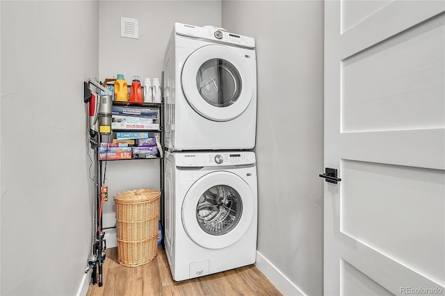 499 Silver Creek Rd, Idaho Springs, CO 80452 - laundry area with stacked washer / dryer, wood finished floors, and baseboards
