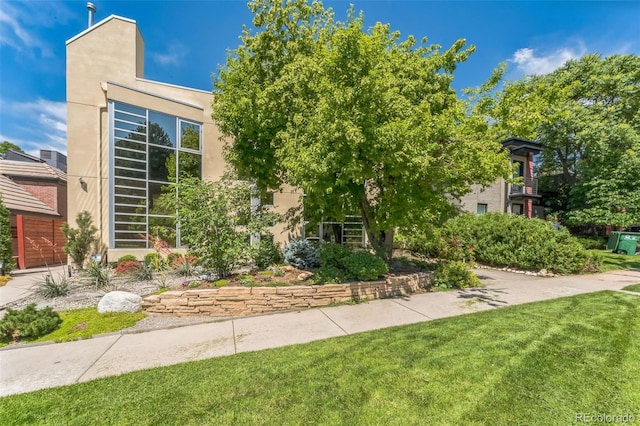 461 Fillmore St, Denver, CO 80206 - view of front of property with a front yard and stucco siding