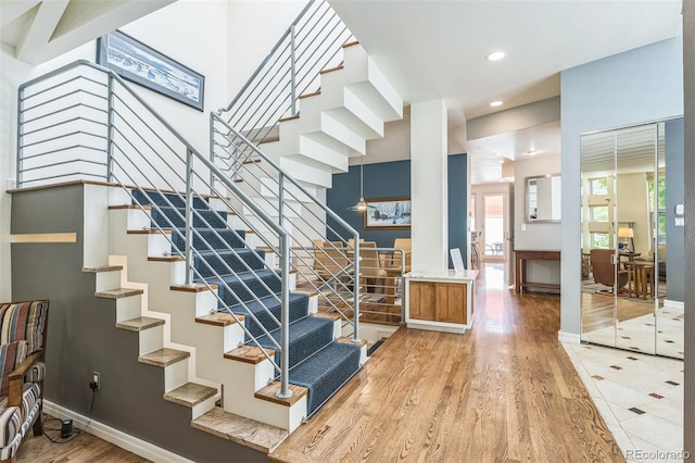 461 Fillmore St, Denver, CO 80206 - staircase with wood finished floors, healthy amount of natural light, and recessed lighting