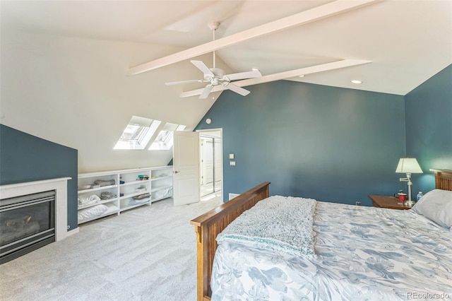 461 Fillmore St, Denver, CO 80206 - carpeted bedroom featuring a skylight, a glass covered fireplace, ceiling fan, beam ceiling, and recessed lighting