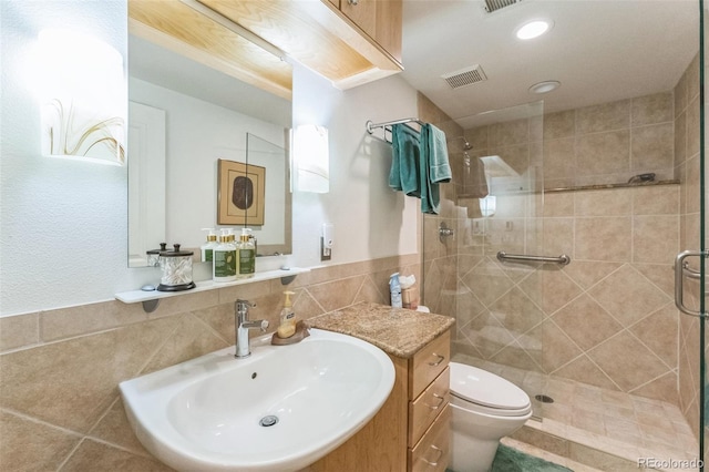 461 Fillmore St, Denver, CO 80206 - full bath featuring a stall shower, tile walls, wainscoting, vanity, and recessed lighting