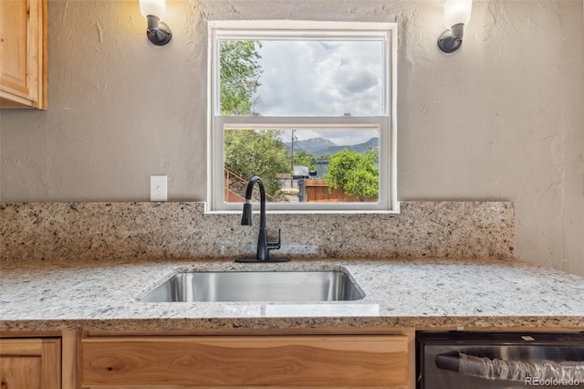 13 Crystal Park Rd, Manitou Springs, CO 80829 - kitchen featuring dishwashing machine, light stone counters, a textured wall, light brown cabinets, and a mountain view