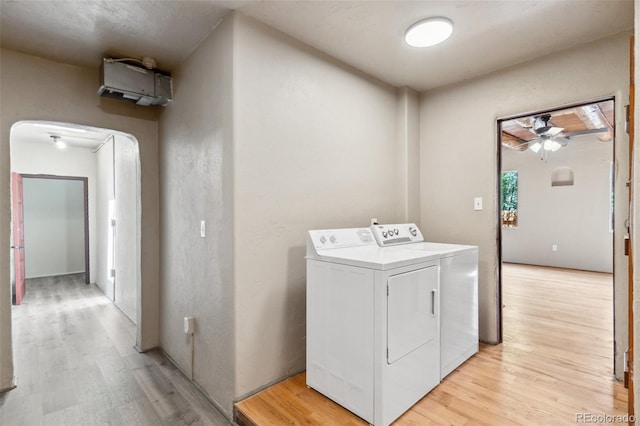 13 Crystal Park Rd, Manitou Springs, CO 80829 - laundry area featuring washing machine and dryer, arched walkways, light wood-style floors, and a ceiling fan