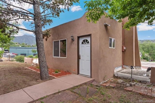 13 Crystal Park Rd, Manitou Springs, CO 80829 - view of exterior entry with a mountain view and stucco siding