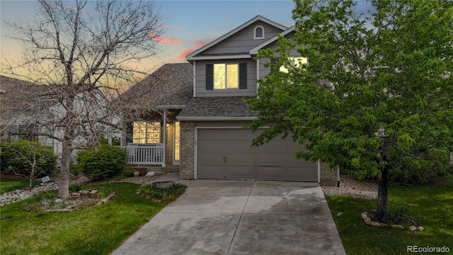 view of front of property with a garage, concrete driveway, a front lawn, brick siding, and roof with shingles