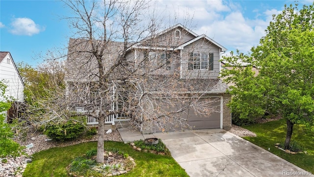 traditional home featuring concrete driveway, brick siding, a garage, and a front lawn