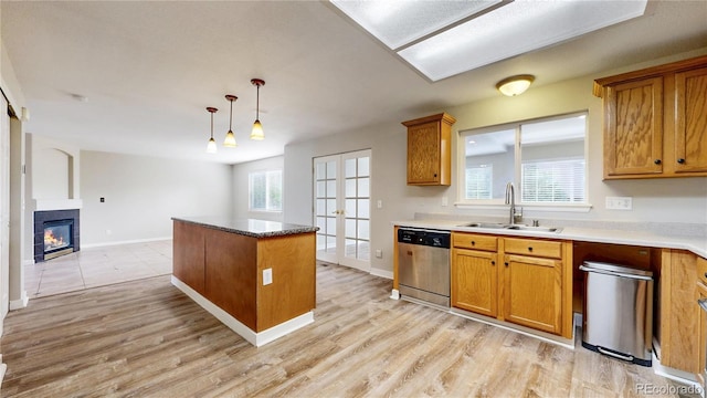 kitchen featuring a sink, brown cabinets, french doors, and dishwasher