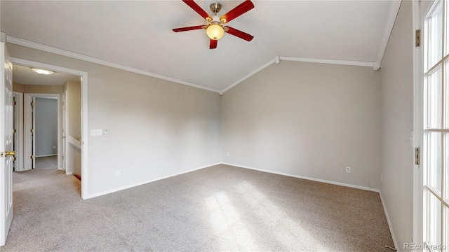 spare room with a ceiling fan, ornamental molding, carpet floors, and vaulted ceiling