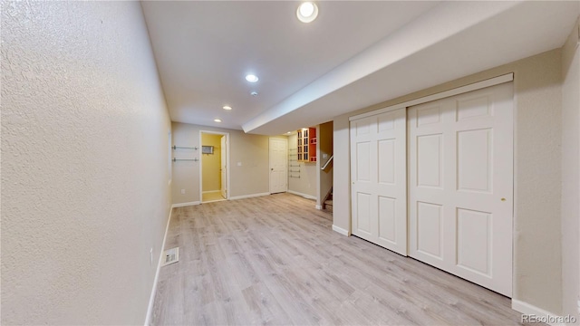 interior space featuring light wood finished floors, stairway, baseboards, and recessed lighting