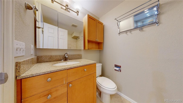 bathroom with tile patterned floors, toilet, visible vents, and vanity