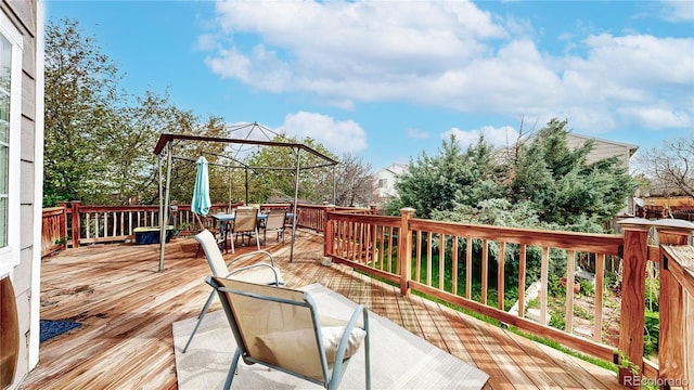 wooden deck featuring outdoor dining space