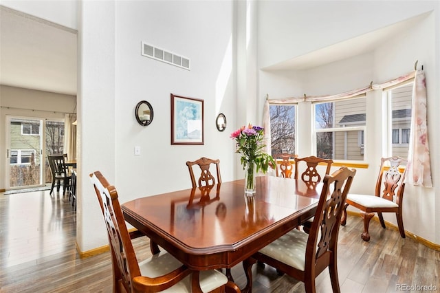 dining space featuring wood finished floors and baseboards