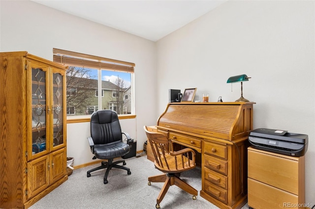 carpeted home office with baseboards