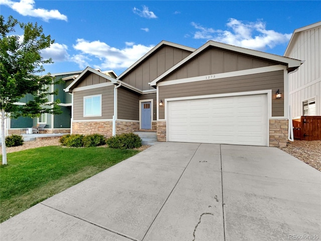 craftsman-style home with a front yard and a garage