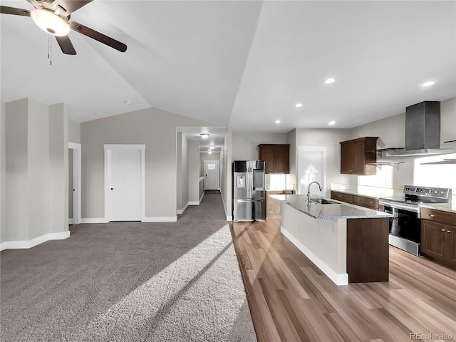 kitchen with a center island with sink, sink, ceiling fan, stainless steel appliances, and extractor fan