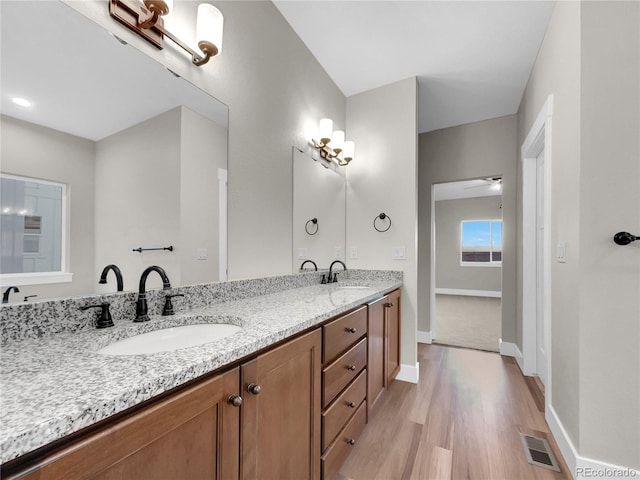 bathroom featuring wood-type flooring, vanity, and ceiling fan