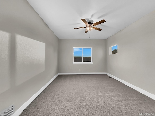 empty room featuring ceiling fan and carpet