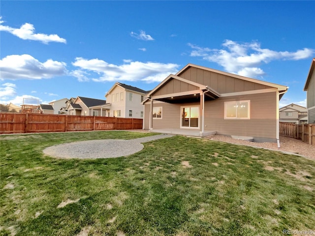 rear view of house featuring a yard and a patio area