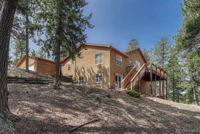 14694 Crooked Trail Rd, Woodland Park, CO 80863 - back of property featuring stairway and a wooden deck