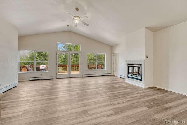 14694 Crooked Trail Rd, Woodland Park, CO 80863 - unfurnished living room featuring baseboard heating, a ceiling fan, lofted ceiling, wood finished floors, and a multi sided fireplace